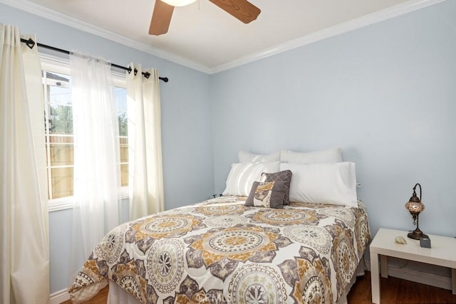 bedroom with ceiling fan, wood finished floors, and crown molding