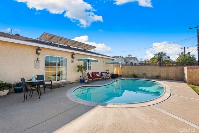 view of swimming pool featuring a fenced in pool, fence, and a patio area