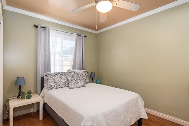 bedroom featuring ornamental molding, a ceiling fan, baseboards, and wood finished floors