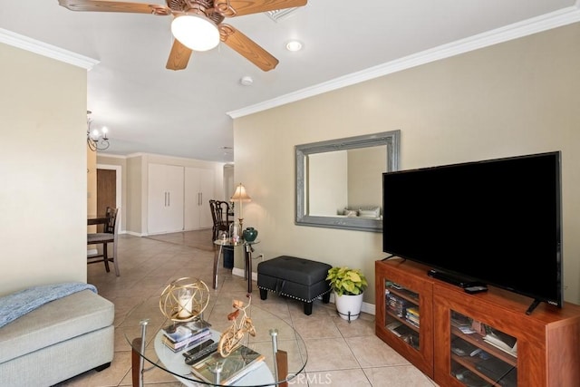 living area with light tile patterned floors, a ceiling fan, crown molding, and baseboards