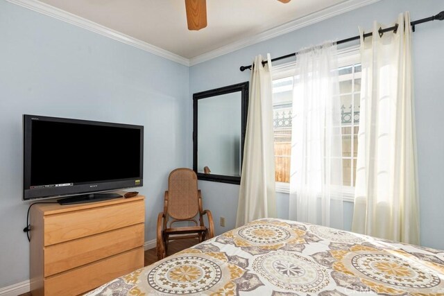 bedroom with baseboards, ceiling fan, and crown molding