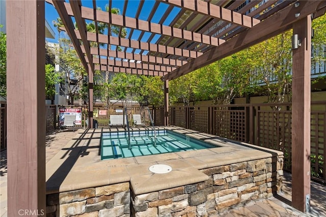 view of swimming pool featuring fence, a pergola, and a hot tub