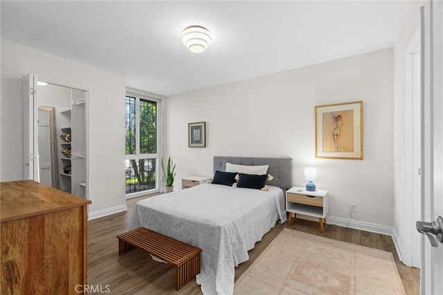 bedroom with wood finished floors and baseboards