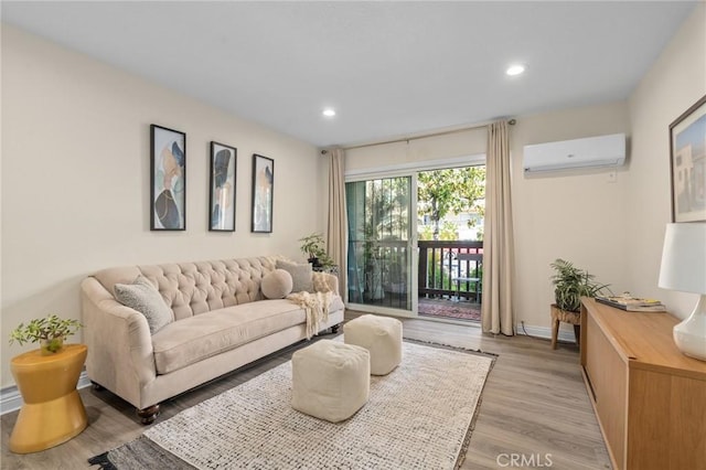 living area with light wood-style flooring, baseboards, a wall mounted AC, and recessed lighting