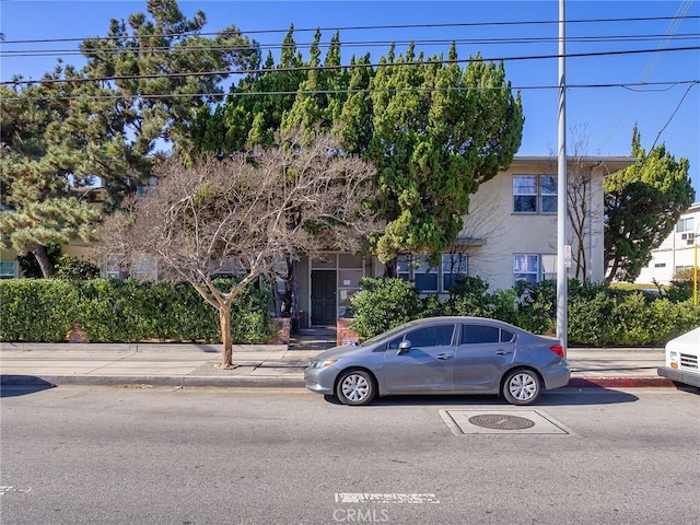 obstructed view of property with stucco siding