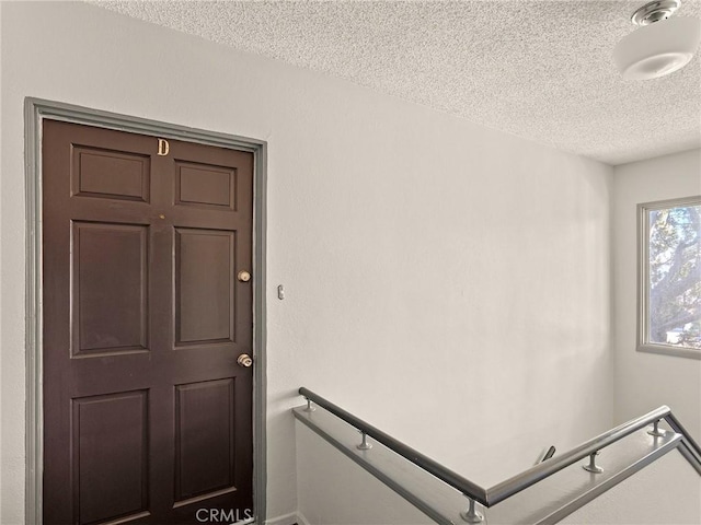 stairway with a textured ceiling