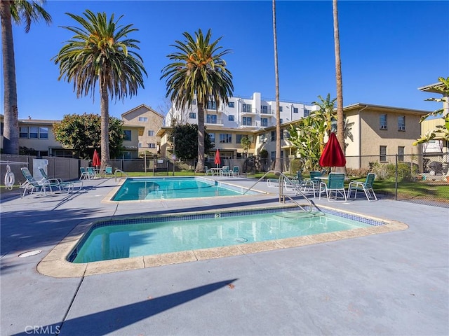 pool featuring a patio area and fence