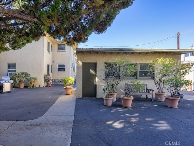 view of front of property with a patio area and stucco siding