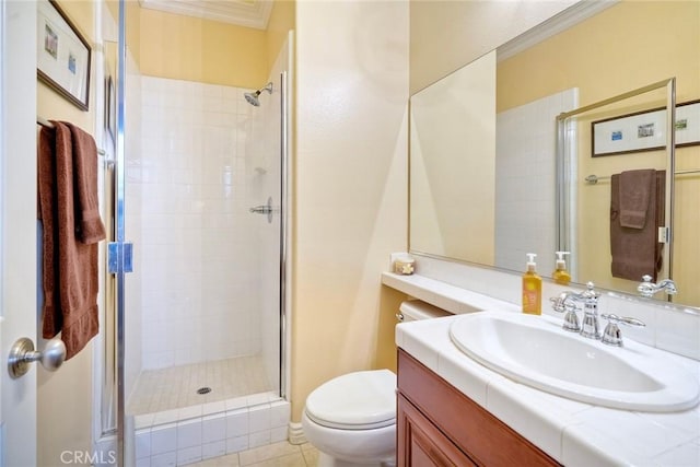 bathroom featuring a shower stall, vanity, toilet, and crown molding