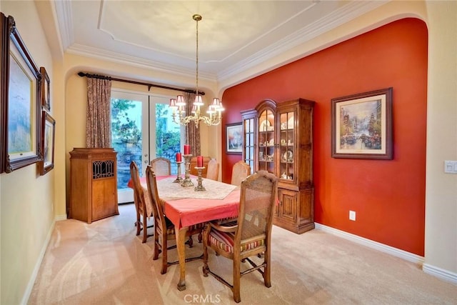 dining room with baseboards, light colored carpet, and ornamental molding