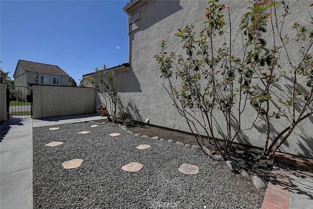 view of yard with fence and a gate