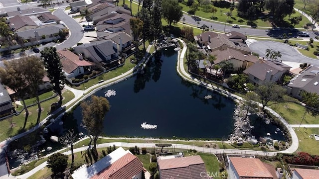 drone / aerial view featuring a residential view and a water view