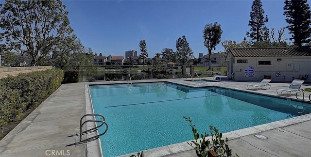 community pool featuring a patio and fence