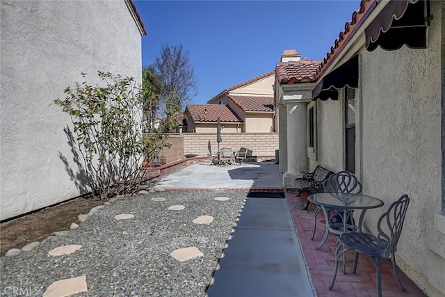 view of patio featuring fence