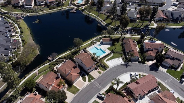 drone / aerial view featuring a residential view and a water view