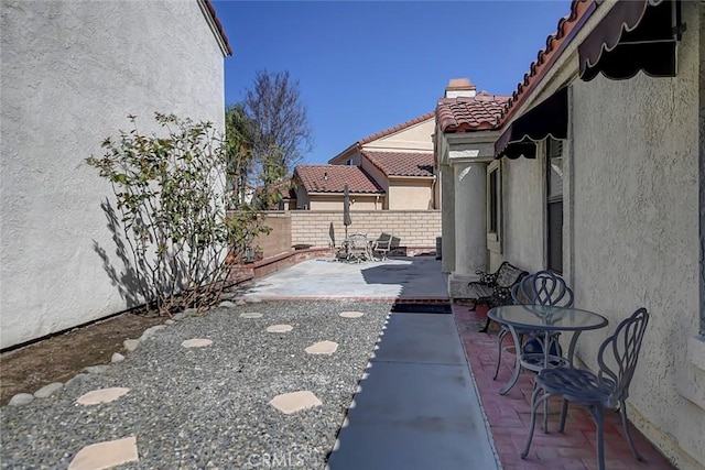 view of patio / terrace featuring fence