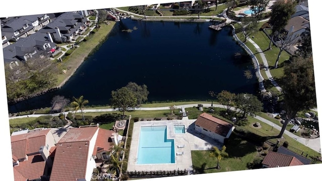 birds eye view of property with a water view