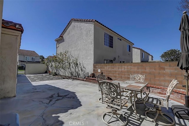 view of patio / terrace with outdoor dining space and fence