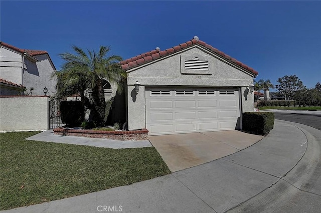 mediterranean / spanish home with a front yard, driveway, stucco siding, a garage, and a tiled roof