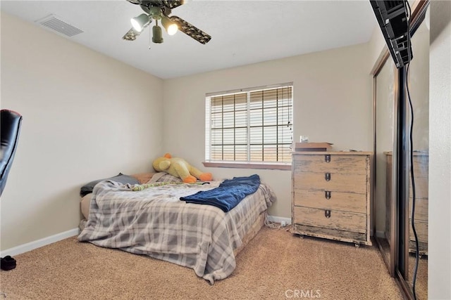 bedroom featuring carpet, baseboards, visible vents, and ceiling fan