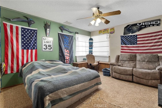 carpeted bedroom with a textured ceiling and ceiling fan