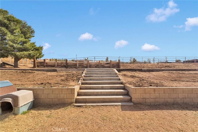 view of yard with stairway and fence