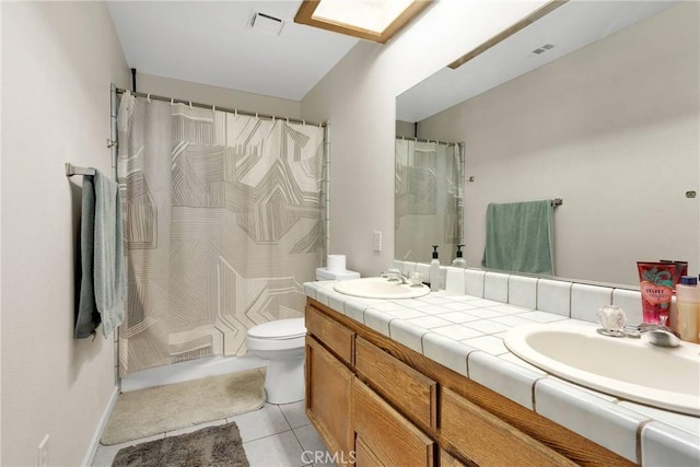 full bathroom with tile patterned floors, double vanity, visible vents, and a sink