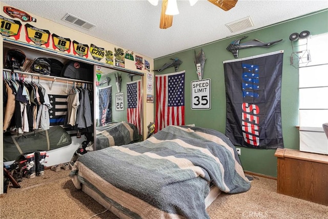 bedroom with visible vents, a closet, and a textured ceiling