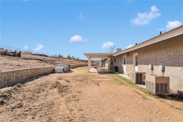 view of yard with a patio, fence, and central AC