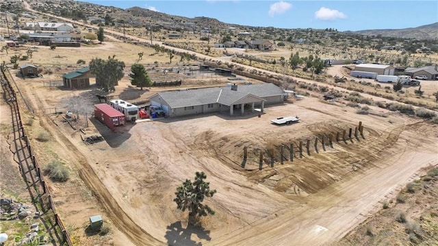 birds eye view of property featuring view of desert, a rural view, and a mountain view