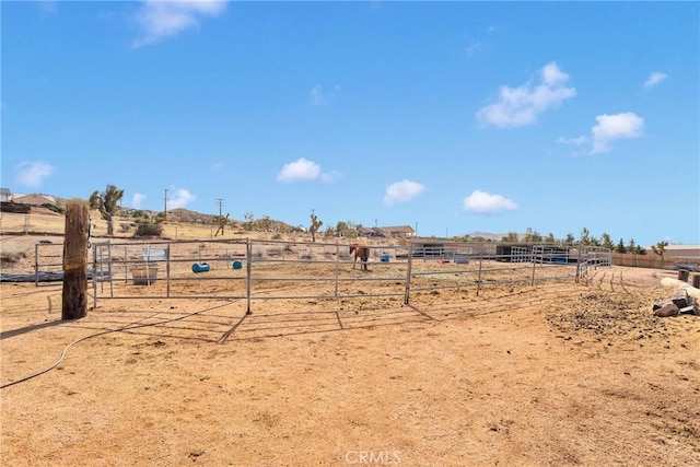 view of yard with a rural view and fence