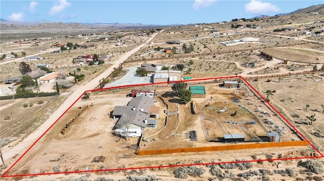 aerial view with a mountain view, a desert view, and a rural view