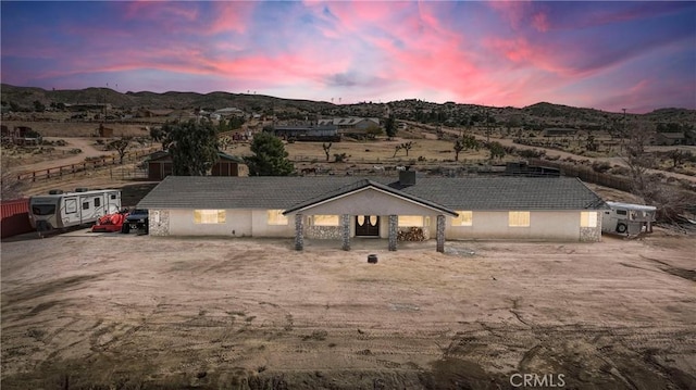 view of front of house featuring a tiled roof and a mountain view