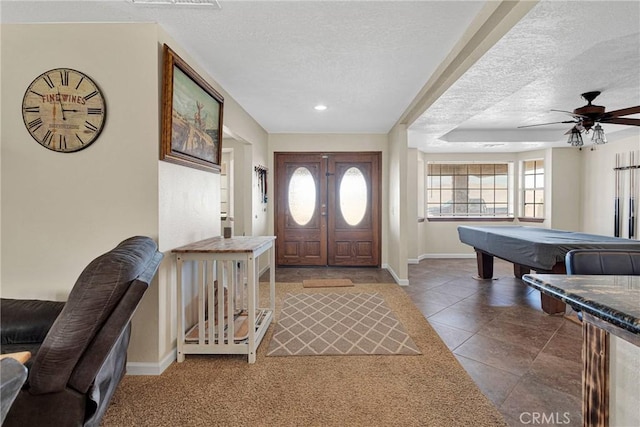 foyer entrance featuring tile patterned floors, pool table, a textured ceiling, and baseboards