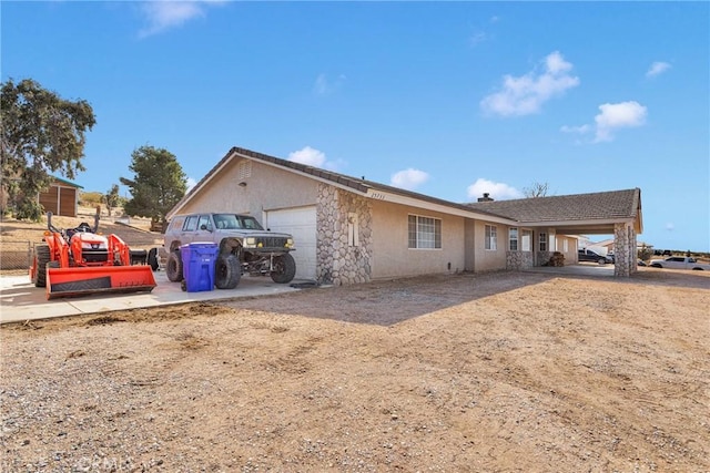 exterior space featuring an attached garage and stucco siding