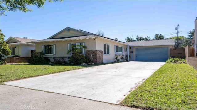 single story home with brick siding, a front lawn, concrete driveway, stucco siding, and an attached garage