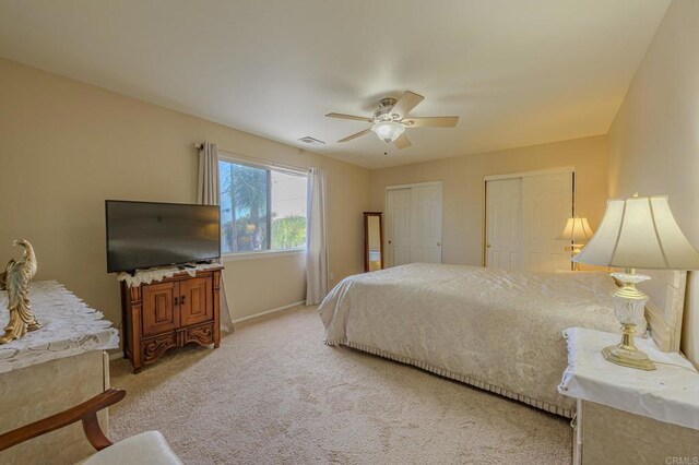 22633 Inspiration Pt, Canyon Lake, CA 92587 - bedroom featuring visible vents, two closets, baseboards, light colored carpet, and a ceiling fan