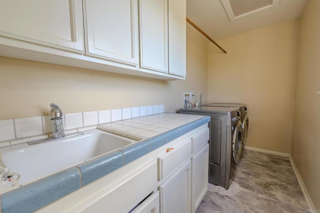 22633 Inspiration Pt, Canyon Lake, CA 92587 - washroom with baseboards, cabinet space, a sink, marble finish floor, and washer and clothes dryer