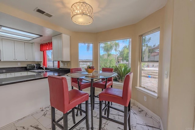 22633 Inspiration Pt, Canyon Lake, CA 92587 - dining room with a toaster, baseboards, visible vents, and marble finish floor