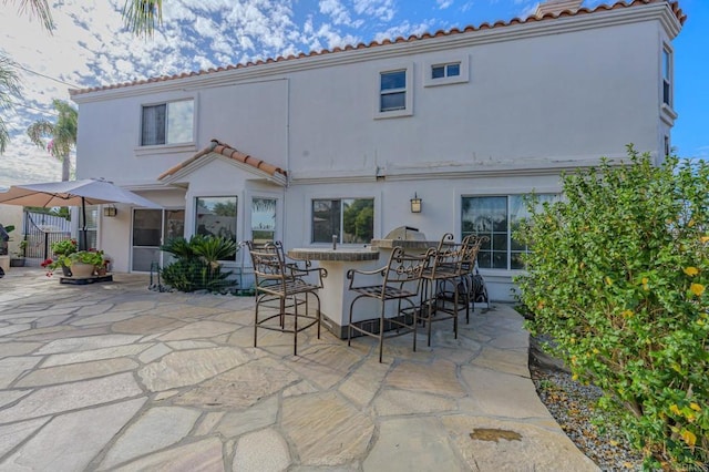 22633 Inspiration Pt, Canyon Lake, CA 92587 - back of property with fence, stucco siding, a tiled roof, a patio area, and outdoor dry bar