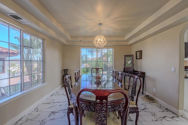 22633 Inspiration Pt, Canyon Lake, CA 92587 - dining room featuring a tray ceiling, arched walkways, baseboards, and a wealth of natural light