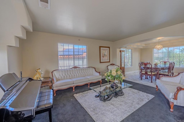 22633 Inspiration Pt, Canyon Lake, CA 92587 - living area featuring visible vents, a tray ceiling, arched walkways, dark colored carpet, and a chandelier