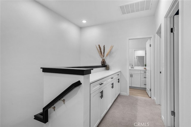 corridor featuring recessed lighting, visible vents, light colored carpet, and baseboards