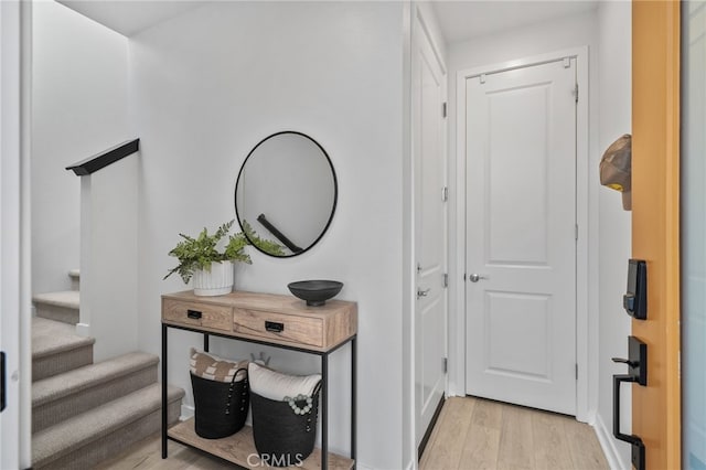 entryway featuring light wood-style flooring and stairs