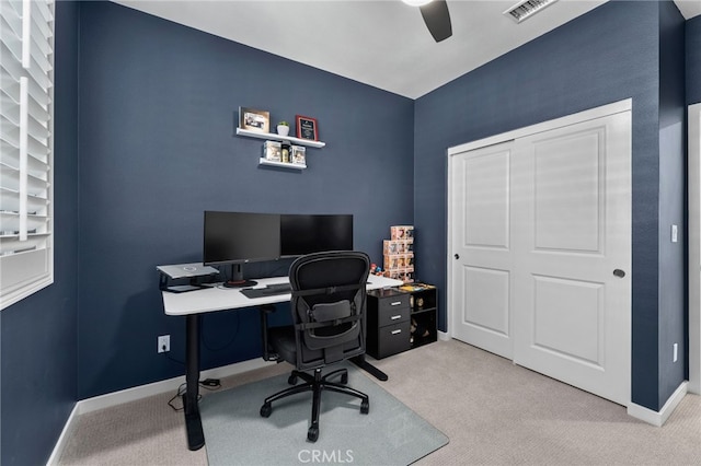 carpeted office space with visible vents, baseboards, and ceiling fan