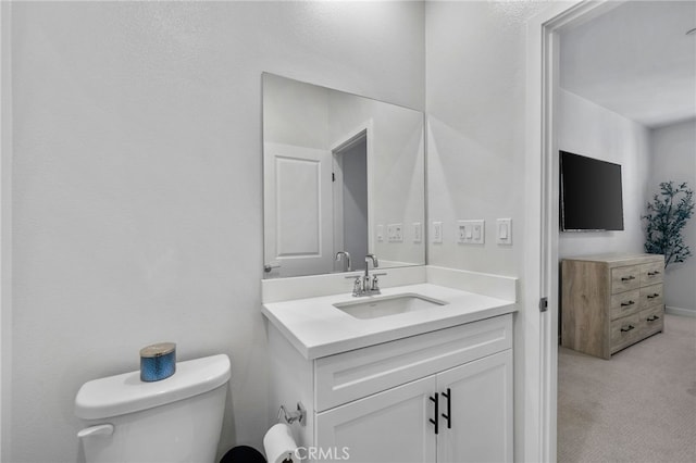 bathroom featuring toilet and vanity