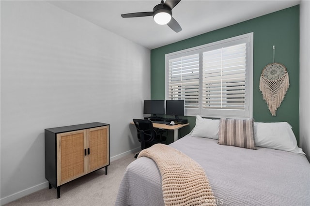 bedroom featuring baseboards, light carpet, and ceiling fan