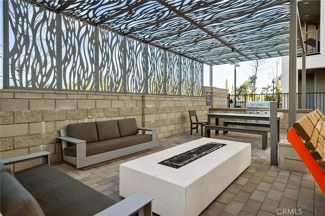 view of patio / terrace featuring grilling area and an outdoor living space with a fire pit