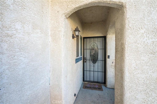 doorway to property with stucco siding