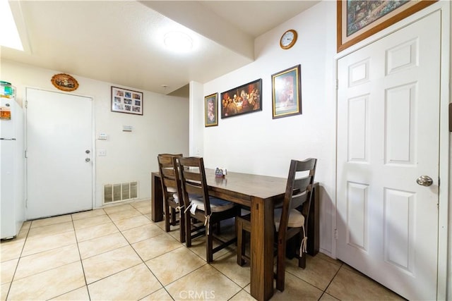 dining space with visible vents and light tile patterned flooring